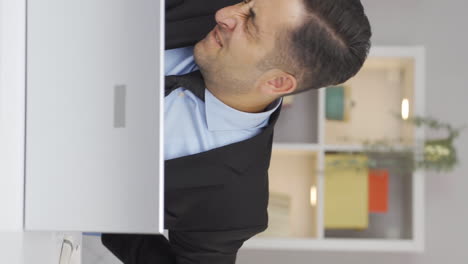Vertical-video-of-Home-office-worker-man-has-lower-back-pain.